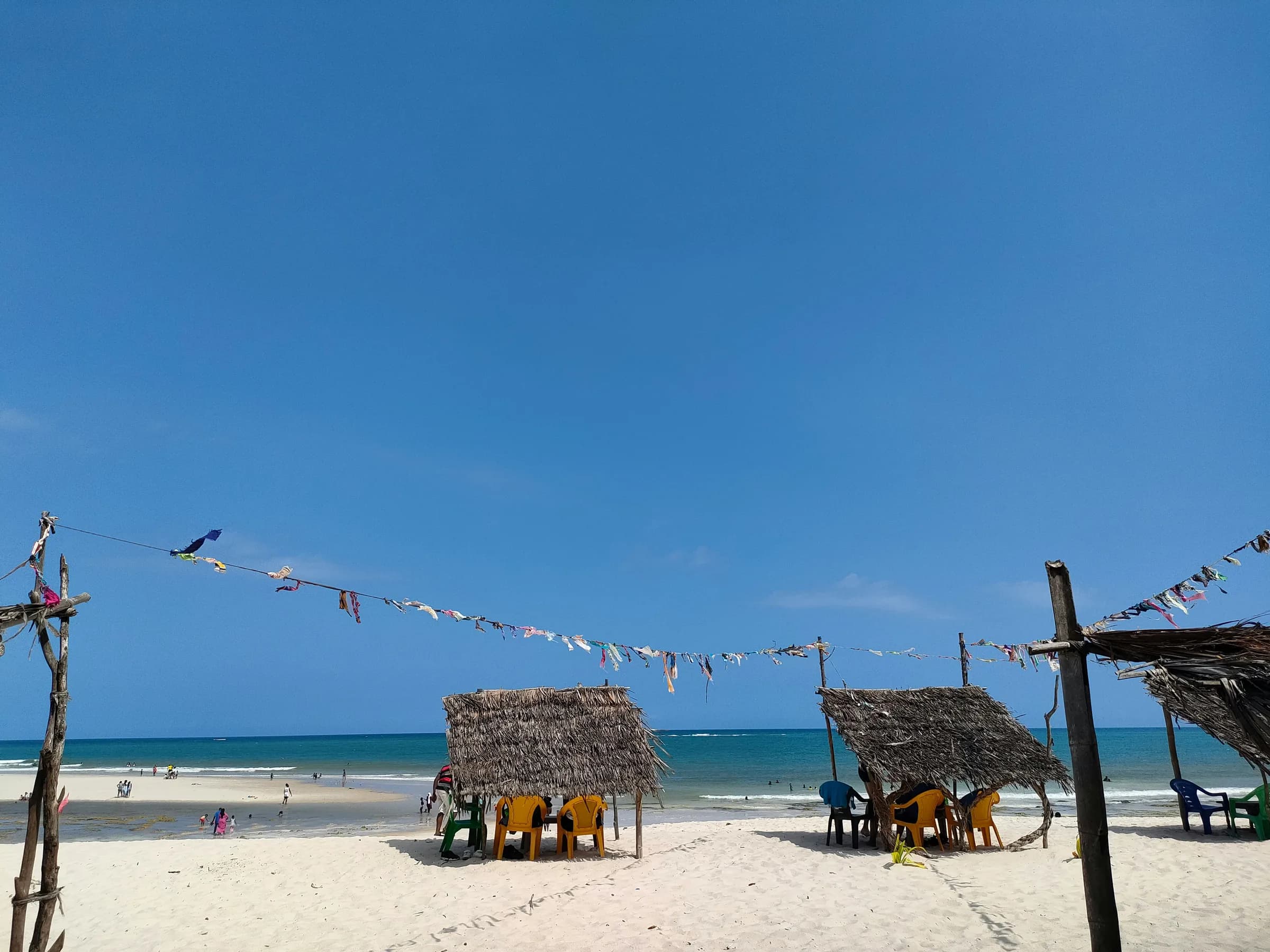 White-sand beach with thatched umbrellas at Diani Beach, Kenyan coast