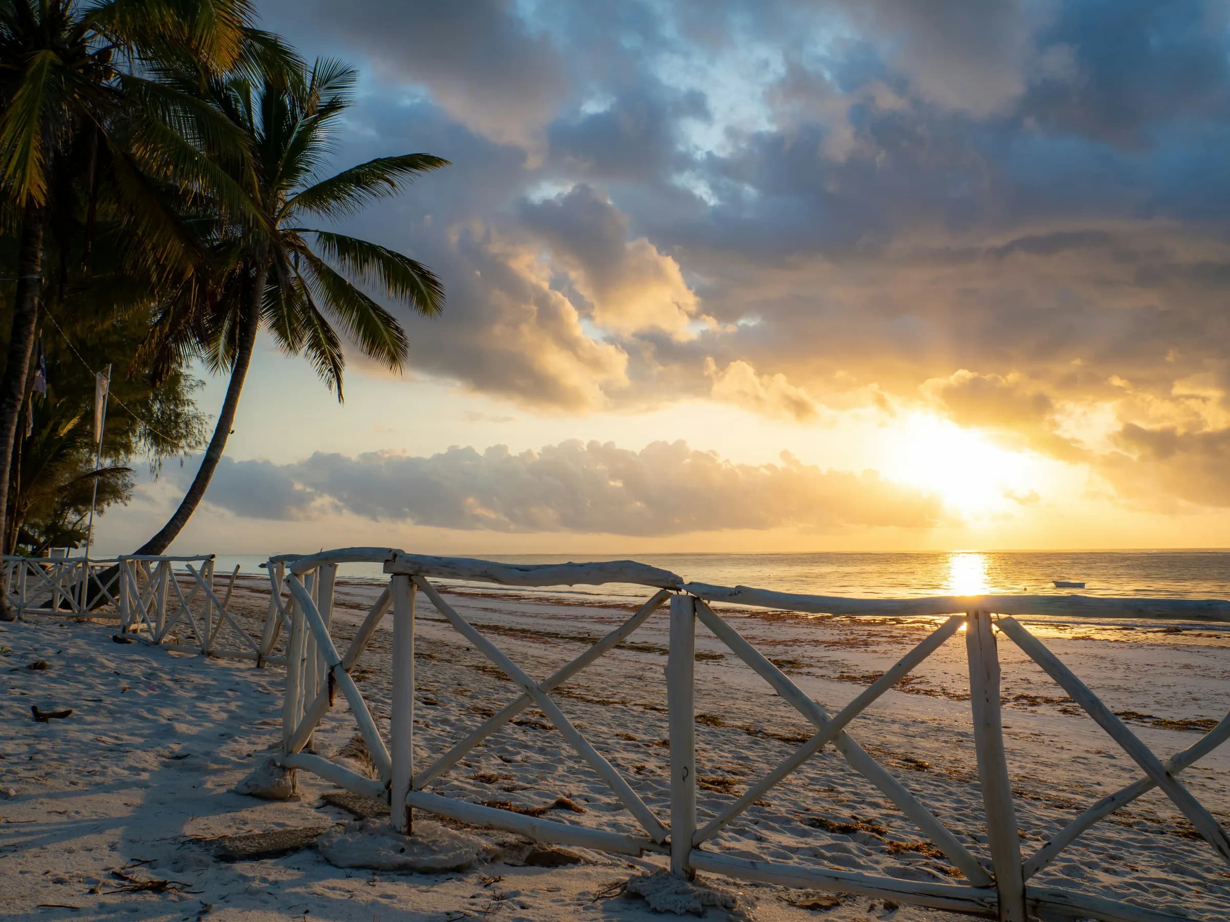 Romantic sunrise over palm-fringed Diani Beach, Kenya